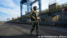 FILE - A Russian soldier patrols an area at the Kakhovka Hydroelectric Station, a run-of-river power plant on the Dnieper River in Kherson region, south Ukraine, on May 20, 2022. Even as the Russian war machine crawls across Ukraineâ€™s east, trying to achieve the Kremlinâ€™s goal of securing a full control over the countryâ€™s industrial heartland of the Donbas, the Ukrainian forces are scaling up attacks to reclaim territory in the south. (AP Photo, File)