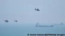 Chinese military helicopters fly past Pingtan island, one of mainland China's closest point from Taiwan, in Fujian province on August 4, 2022, ahead of massive military drills off Taiwan following US House Speaker Nancy Pelosi's visit to the self-ruled island. - China is due on August 4 to kick off its largest-ever military exercises encircling Taiwan, in a show of force straddling vital international shipping lanes following a visit to the self-ruled island by US House Speaker Nancy Pelosi. (Photo by Hector RETAMAL / AFP) (Photo by HECTOR RETAMAL/AFP via Getty Images)