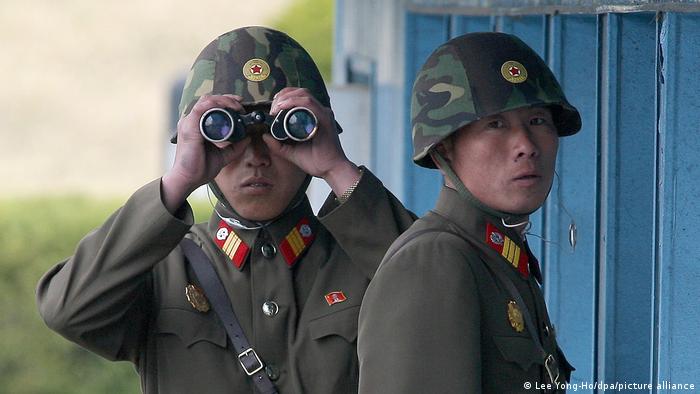 A North Korean solider looks through binoculars 