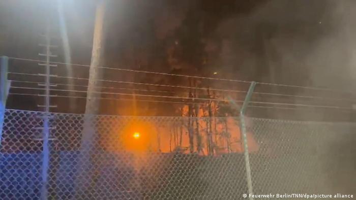 Fire in Berlin's Grunewald seen through fence