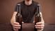 Young man holding two bottles of beer. Young man holding two bottles of beer.