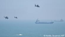 Chinese military helicopters fly past Pingtan island, one of mainland China's closest point from Taiwan, in Fujian province on August 4, 2022, ahead of massive military drills off Taiwan following US House Speaker Nancy Pelosi's visit to the self-ruled island. - China is due on August 4 to kick off its largest-ever military exercises encircling Taiwan, in a show of force straddling vital international shipping lanes following a visit to the self-ruled island by US House Speaker Nancy Pelosi. (Photo by Hector RETAMAL / AFP)