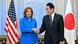 US House Speaker Nancy Pelosi shakes hands with Japanese Prime Minister Fumio Kishida in front of an American flag and a Japanese flag US House Speaker Nancy Pelosi shakes hands with Japanese Prime Minister Fumio Kishida in front of an American flag and a Japanese flag