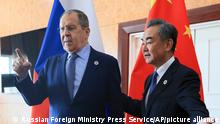 In this photo released by Russian Foreign Ministry Press Service, Russian Foreign Minister Sergey Lavrov, left, and Chinese Foreign Minister Wang Yi gesture while posing for a photo prior to their talks on the sideline of the 12th East Asia Summit foreign ministers' meeting in Phnom Penh, Cambodia, Friday, Aug. 5, 2022. (Russian Foreign Ministry Press Service via AP)