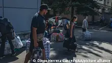 BAKHMUT, UKRAINE - AUG 4: People wait for buses in order to be evacuated in Bakhmut, Ukraine, 4 August 2022. Diego Herrera Carcedo / Anadolu Agency