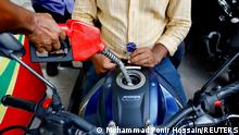 People refuel their motorcycles at a gasoline station after fuel price surge up to fifty percent in Dhaka, Bangladesh, August 6, 2022. REUTERS/Mohammad Ponir Hossain