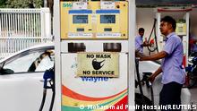 A man refuels a car at a gasoline station after price surge up to fifty percent in Dhaka, Bangladesh, August 6, 2022. REUTERS/Mohammad Ponir Hossain
