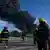 Firefighters are seen near an oil tank on fire in Matanzas, Cuba