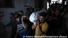 Relatives of Palestinian Noor Al Zubaidi, who was killed during an israeli airstrike in Beit Hanoun north of Gaza City, carry his body during his funeral at Al shifa hospital in Gaza City. Aug. 6, 2022. (AP Photo/Fatima Shbair)