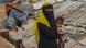 A veiled woman holds a small child in Cox Bazar A veiled woman holds a small child in Cox Bazar