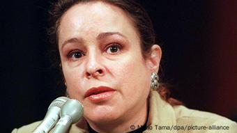  Alina Castro sitzt vor einem Mikrofon 