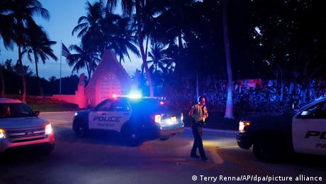 Police cars and a policeman stand guard near Trump's Mar-a-Lago resort