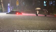 A vehicle is submerged in a flooded road in Seoul, Monday, Aug. 8, 2022. Heavy rains drenched South Korea's capital region, turning the streets of Seoul's affluent Gangnam district into a river, leaving submerged vehicles and overwhelming public transport systems. (Hwang Kwang-mo/Yonhap via AP)