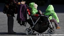 FILE PHOTO: An elderly woman pushes two babies in a stroller in Beijing, October 30, 2015. REUTERS/Kim Kyung-Hoon/File Photo