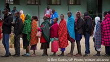 People line up to vote at the Oltepesi Primary School, Kajiado County in Nairobi, Kenya, Tuesday Aug. 9, 2022. Kenyans are voting to choose between opposition leader Raila Odinga and Deputy President William Ruto to succeed President Uhuru Kenyatta after a decade in power. (AP Photo/Ben Curtis)