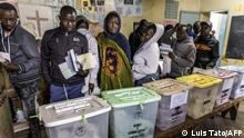A group of voters queue while waiting to vote in front on ballot boxes at a polling station during the Kenya's general election at St. Stephen School in the informal settlement of Mathare in Nairobi, Kenya, on August 9, 2022. (Photo by Luis Tato / AFP)