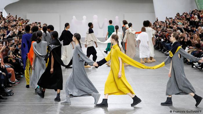 Connected by fabric or held hands, models at a Issey Miyake fashion show in Paris, 2020
