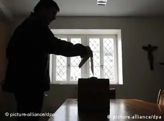 A person casts his ballots in Bauen, Switzerland