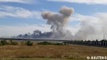 Smoke rises after explosions were heard from the direction of a Russian military airbase near Novofedorivka, Crimea, in this still image obtained by Reuters August 9, 2022. THIS IMAGE HAS BEEN SUPPLIED BY A THIRD PARTY.