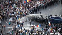 Riot police use water cannon against protesters in front of the Romanian Government headquarters in Bucharest, Romania on August 10, 2018. (Photo by Adrian CATU / AFP) (Photo credit should read ADRIAN CATU/AFP via Getty Images)
