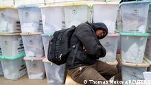 10.08.2022*****A polling staff sleeps next to the sealed ballot boxes containing electoral materials at an Independent Electoral and Boundaries Commission (IEBC) tallying centre after the general election in Nairobi, Kenya August 10, 2022. REUTERS/Thomas Mukoya