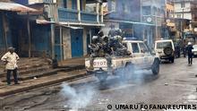 Riot police patrol as they pass smoke rising from a roadblock during anti-government protests in Freetown, Sierra Leone August 10, 2022. REUTERS/Umaru Fofana