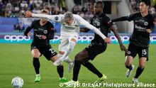 Real Madrid's Federico Valverde, second left, duels for the ball with Frankfurt's Christopher Lenz, left, and Frankfurt's Evan N'Dicka, second right, during the UEFA Super Cup final soccer match between Real Madrid and Eintracht Frankfurt at Helsinki's Olympic Stadium, Finland, Wednesday, Aug. 10, 2022. (AP Photo/Sergei Grits)
