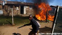 A man holding a machete reacts next to a fire after community members burned shacks and belongings as they searched for alleged illegal miners known as ‘zama-zamas’ as a protest, following alleged rape of eight models on July 28 when a television crew filmed a music video at a mine dump in the nearby township, in the West Rand, South Africa, August 8, 2022. REUTERS/Siphiwe Sibeko
TPX IMAGES OF THE DAY 