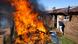 A man runs past a fire after community members burned shacks and belongings as they searched for alleged illegal miners known as ‘zama-zamas’ as a protest, following the alleged rape of eight models. A man runs past a fire after community members burned shacks and belongings as they searched for alleged illegal miners known as ‘zama-zamas’ as a protest, following the alleged rape of eight models.