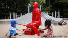 Children play by a statue of Russian President Vladimir Putin riding a tank created by French artist James Colomina in Central Park in Manhattan, New York City, U.S., August 2, 2022. REUTERS/Andrew Kelly