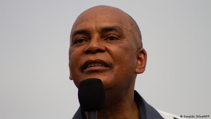 Headshot of a man holding a microphone