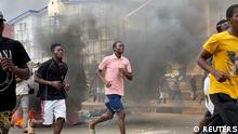 People run away during an anti-government protest, in Freetown, Sierra Leone, August 10, 2022 in this picture obtained from social media. Picture obtained by Reuters/via REUTERS THIS IMAGE HAS BEEN SUPPLIED BY A THIRD PARTY. MANDATORY CREDIT.