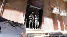 14.08.2022
Security members stand at the scene where a deadly fire broke out at the Abu Sifin church in Giza, Egypt, August 14, 2022. REUTERS/Mohamed Abd El Ghany

