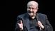 Salman Rushdie holding a microphone. Salman Rushdie holding a microphone.
