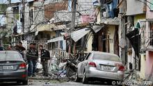 Members of the National Police inspect the site of an explosion, which the Ecuadorean government attributes to organized crime, in southern Guayaquil, Ecuador, on August 14, 2022. - Five people died and 20 were injured in an explosion Sunday in the Ecuadoran port city of Guayaquil in an attack the government blamed on organized crime, officials said. (Photo by Marcos PIN / AFP)