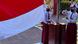 Dua orang pelajar saat upacara pengibaran bendera Indonesia Dua orang pelajar saat upacara pengibaran bendera Indonesia