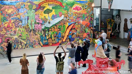 visitors view and photograph a large artwork