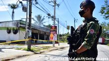 Thai military personnel guards convenience stores damaged after an attack, in Cho-airong district in southern Thailand's Narathiwat province, on August 17, 2022. - Several arsons and explosions rocked multiple locations in Thailand's three southernmost provinces in the night of August 16 and 17, 2022. (Photo by Madaree TOHLALA / AFP) (Photo by MADAREE TOHLALA/AFP via Getty Images)