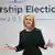 Liz Truss gestures with both hands during a campaign speech
