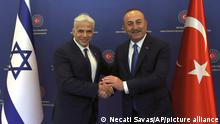 Turkish Foreign Minister Mevlut Cavusoglu, right, and Israeli Foreign Minister Yair Lapid pose for photos before their talks, in Ankara, Turkey, Thursday, June 23, 2022. Turkish authorities have detained five Iranian suspected of planning attacks against Israelis, Turkish media reports said Thursday, ahead of a visit to Turkey by Lapid. Lapid met Cavusoglu on Thursday as the two countries press ahead with efforts to repair ties that have been strained over Turkey's strong support for the Palestinians. (Necati Savas, Pool Photo via AP)