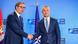 NATO chief Jens Soltenberg and Serbian President Aleksandar Vucic shaking hands in front of NATO and Serbian flags NATO chief Jens Soltenberg and Serbian President Aleksandar Vucic shaking hands in front of NATO and Serbian flags