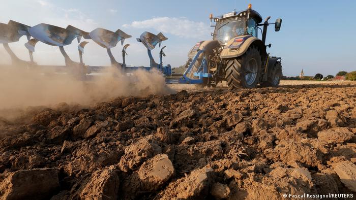 A tractor plowing dry soil