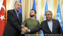 Ukrainian President Volodymyr Zelenskyy, center, Turkish President Recep Tayyip Erdogan, left, and United Nations Secretary General Antonio Guterres shake hands after their meeting in Lviv, Ukraine, Thursday, Aug. 18, 2022. (AP Photo/Evgeniy Maloletka)