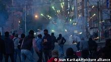 Coca farmers launch fireworks at the police during the third week of clashes near a coca leaf market in La Paz, Bolivia, Monday, Aug. 15, 2022. Coca farmers are demanding that the government ban the parallel coca market that they say is run by unions close to the government. (AP Photo/Juan Karita)