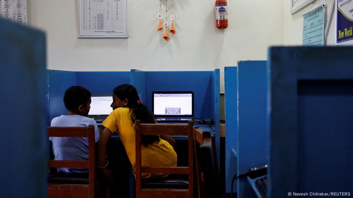 Parwati Sunar attends a computer course with her son after school.