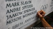A stone cutter renovates a memorial stone for the 11 Israeli athletes killed by Palestinian militants during the 1972 Olympic Games, at the site of the hostage-taking at the former Olympic Village in Munich, Germany, August 18, 2022. REUTERS/Wolfgang Rattay