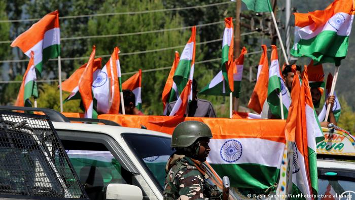 Indian flags waving above a soldier 