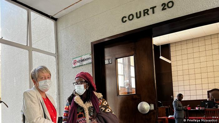 Julie Barnes and Tsitsi Dangarembga wearing face masks outside the courtroom in Harare