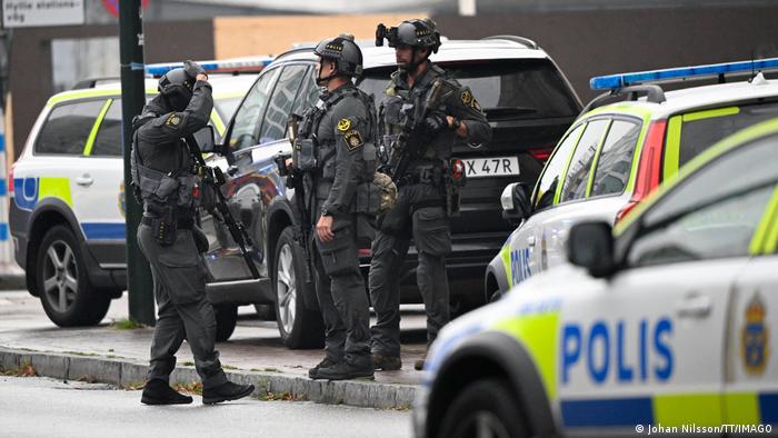 Police vehicles are seen in Malmo, Sweden, near a crime scene.