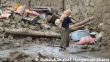 21.08.2022
A woman walks by her damaged homs after heavy flooding in the Khushi district of Logar province south of Kabul, Afghanistan, Sunday, Aug. 21, 2022. (AP Photo/Shafiullah Zwak)